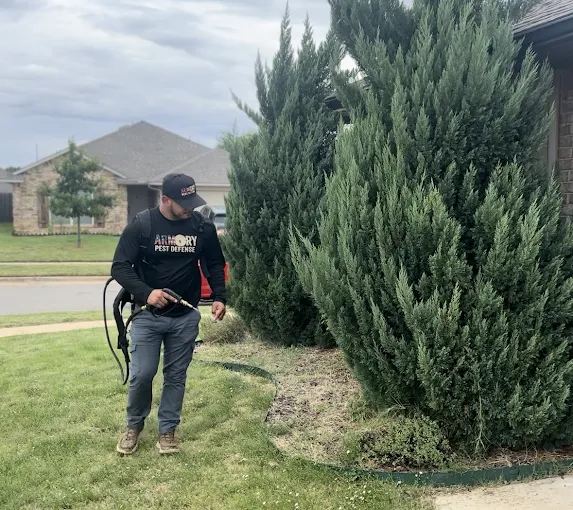 Armory Pest Defense technician treating an Oklahoma home exterior