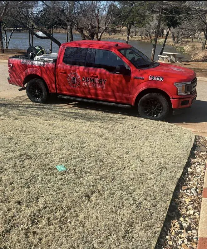 Armory Pest Defense technician treating a home exterior